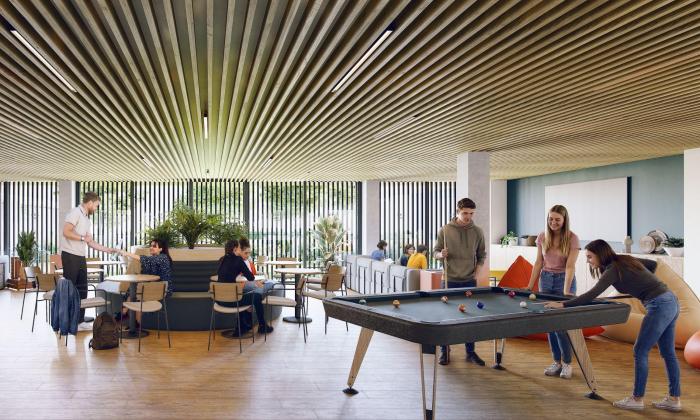 Zona común de una residencia de estudiantes en Zaragoza con mesa de billar y área de estudio